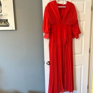 Bella Barnett Beautiful orange dress with high slit and deep neckline